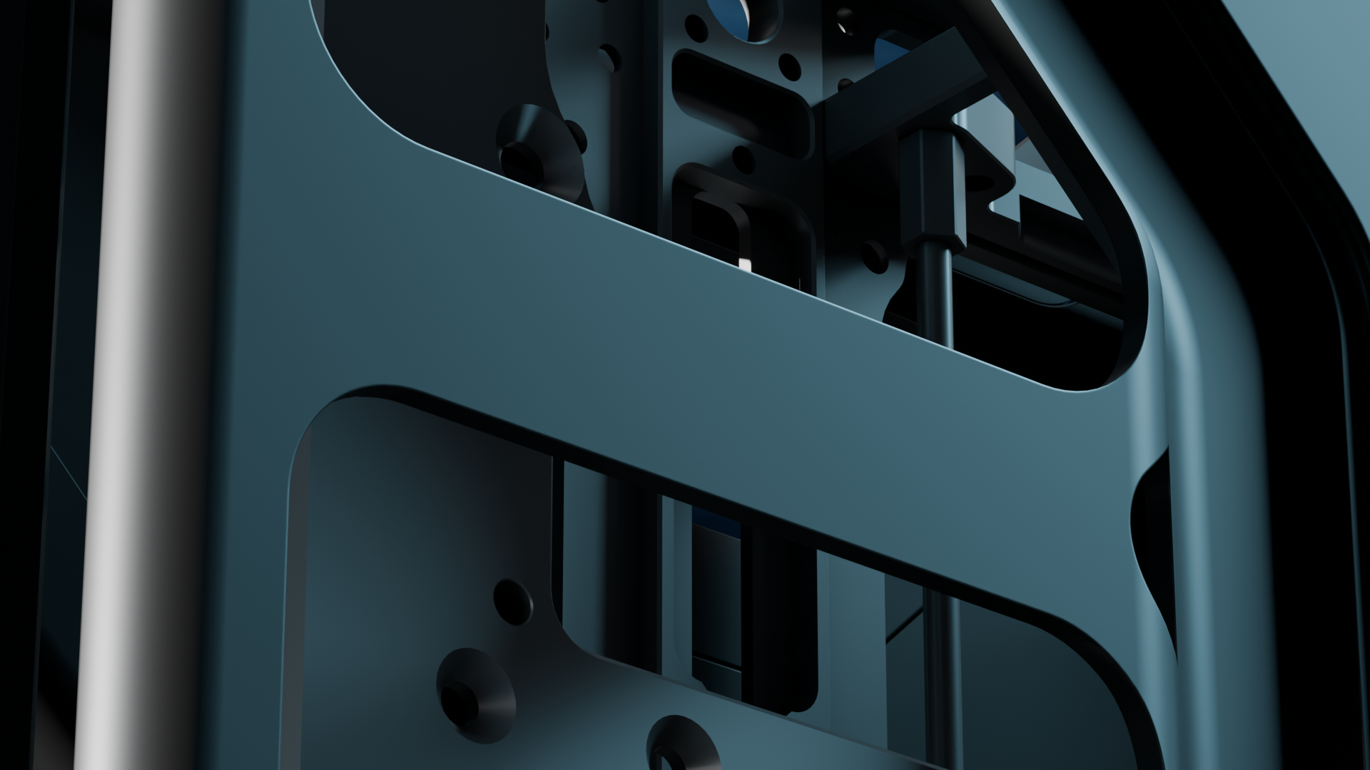 Close-up of dark metal mechanical structure with holes and angular components.