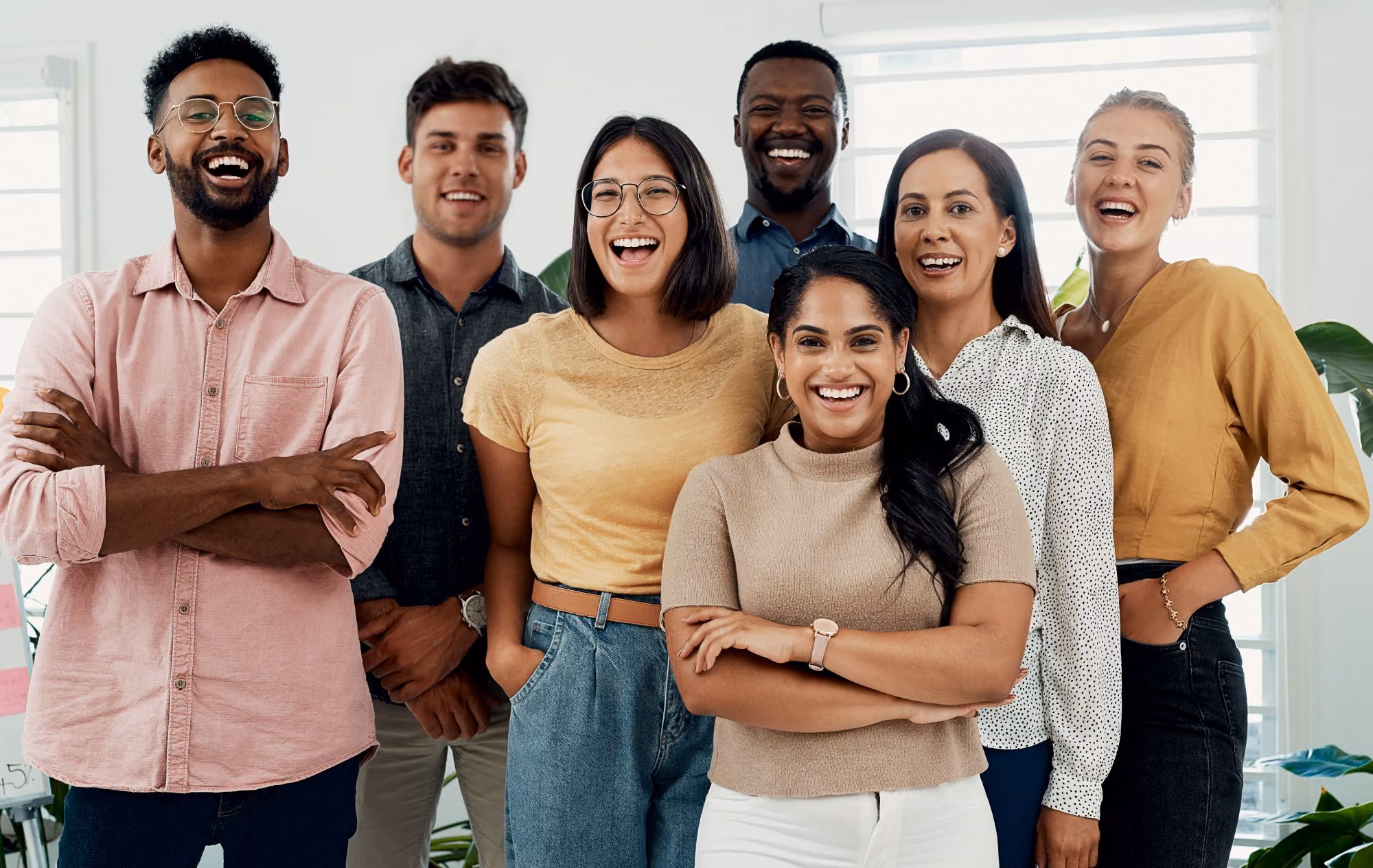 Group of people standing together, smiling.