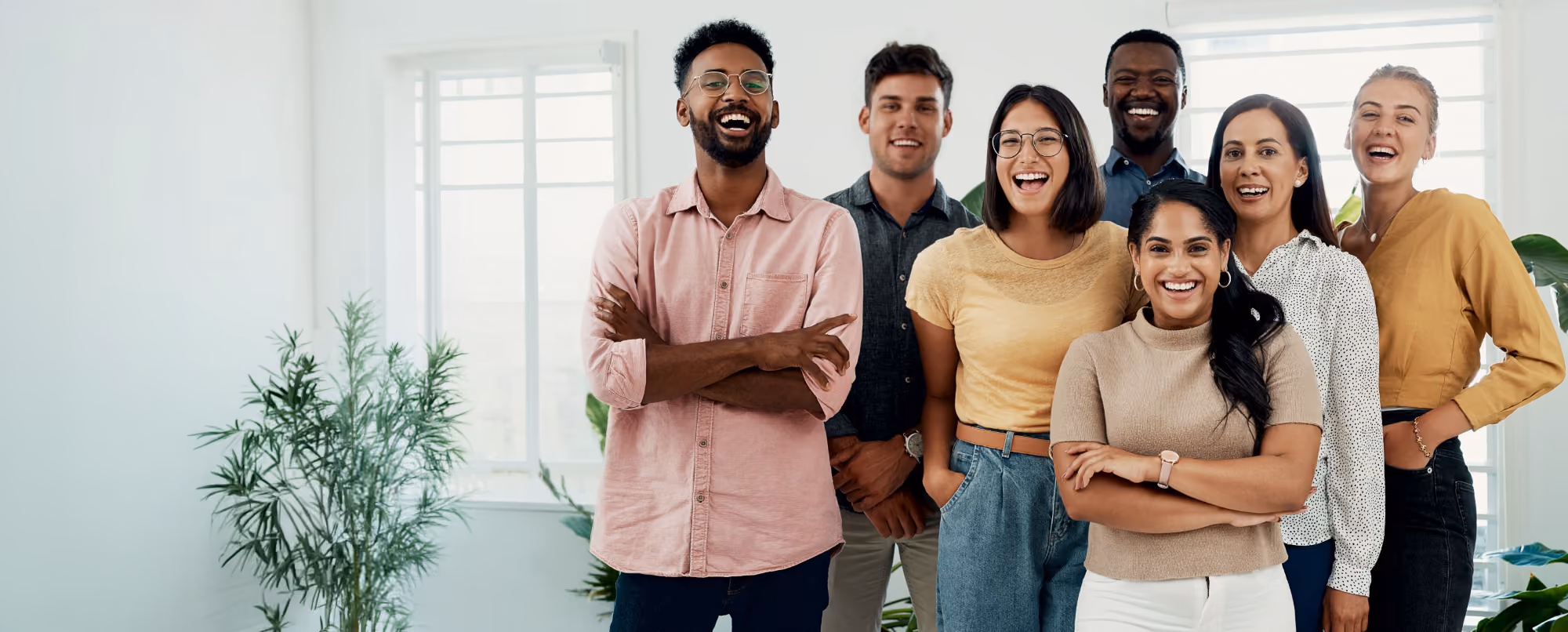 Group of people standing together, smiling.