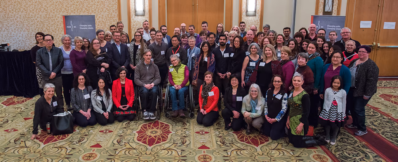 Large group photo of Pain BC staff and community members at an event.