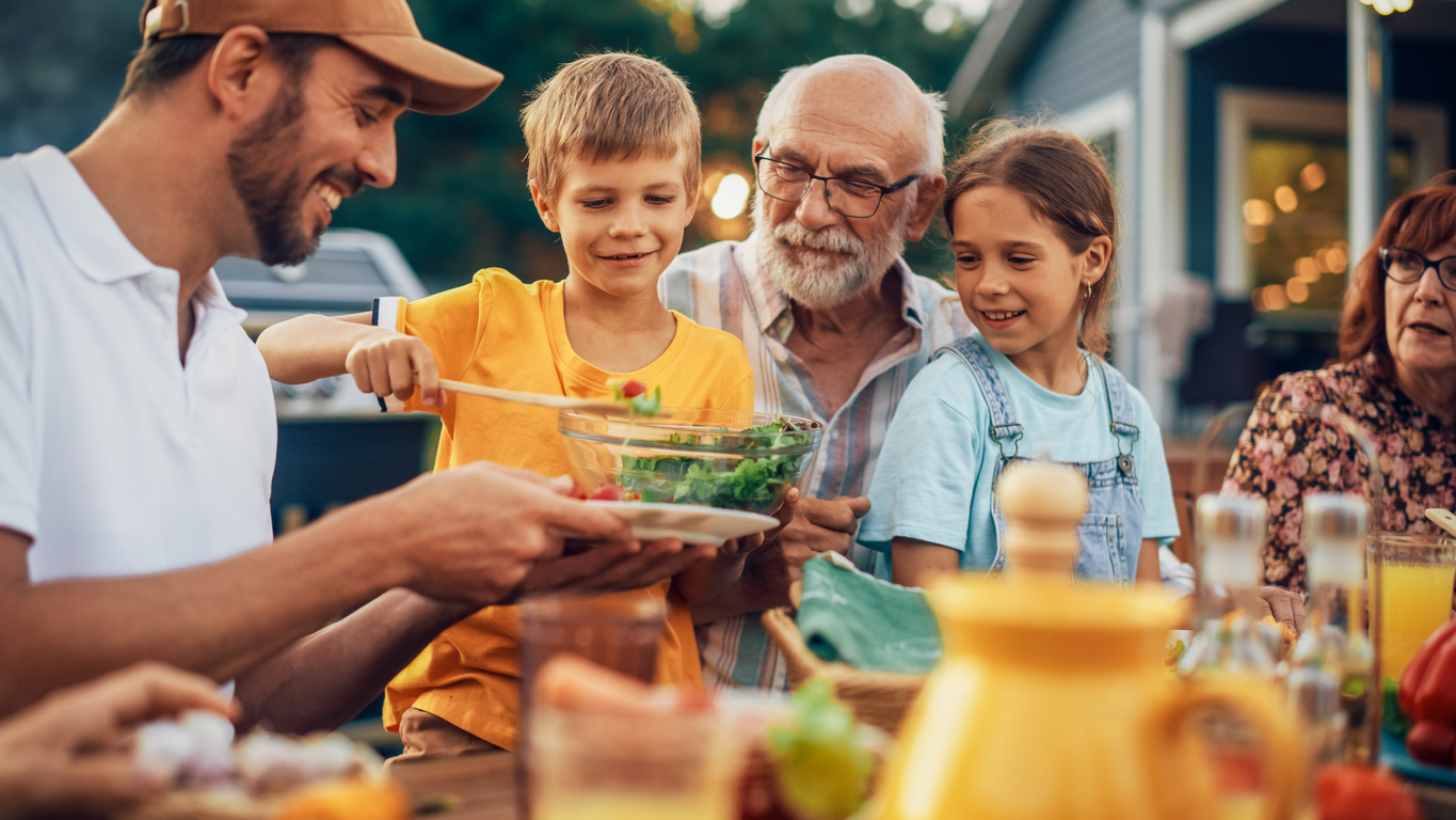 A family shares a happy picnic.