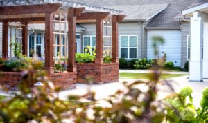 Raised garden beds and wooden pergolas in a landscaped area at Clear Creek, Fayetteville, AR, showcasing the community's outdoor space for residents.