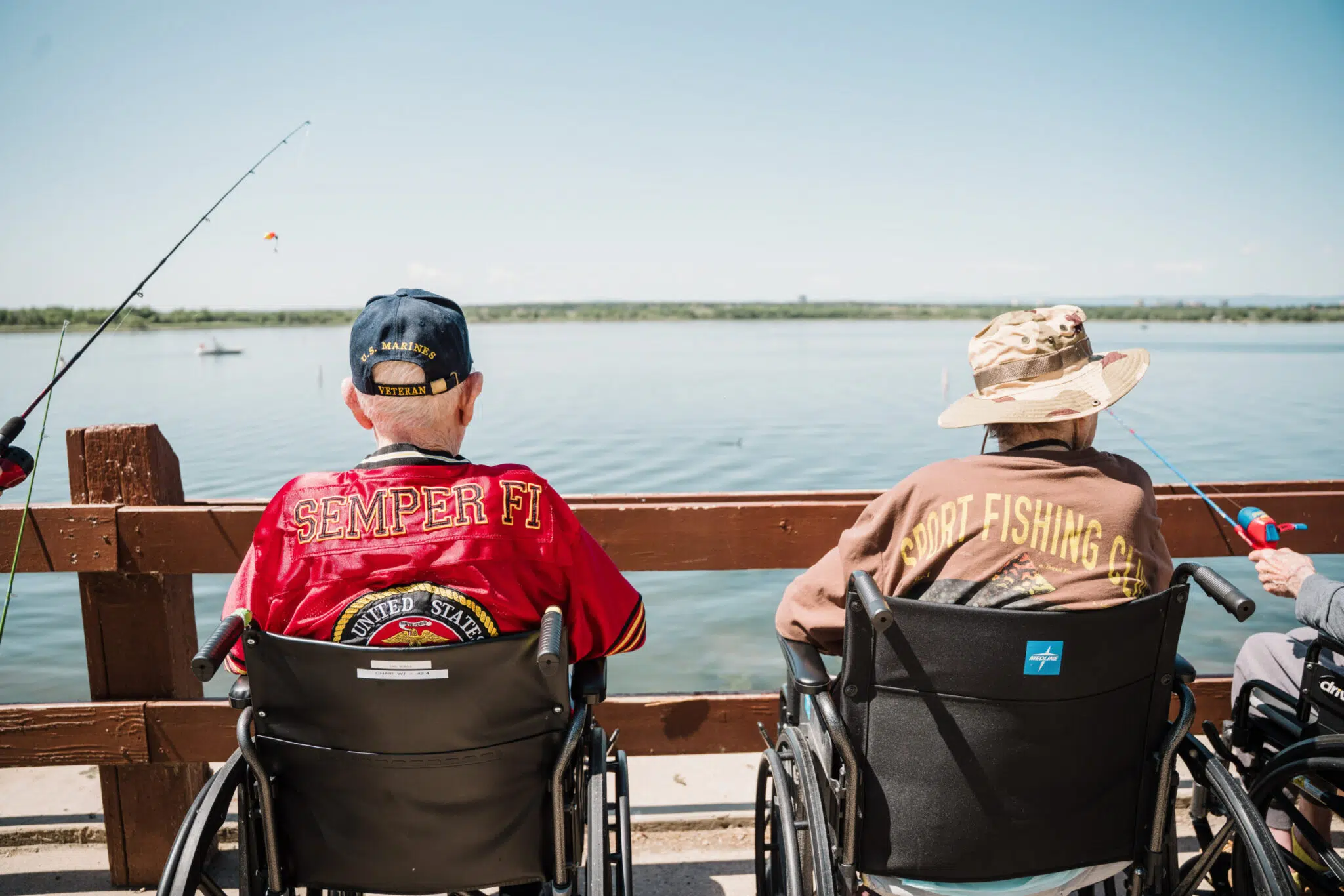 2 gentleman in wheelchairs fishing