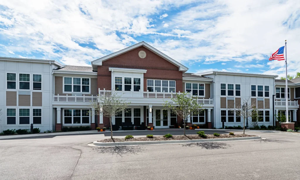 Emerald Place memory care community building in Glenview, IL, featuring a welcoming entrance, landscaped surroundings, and an American flag.