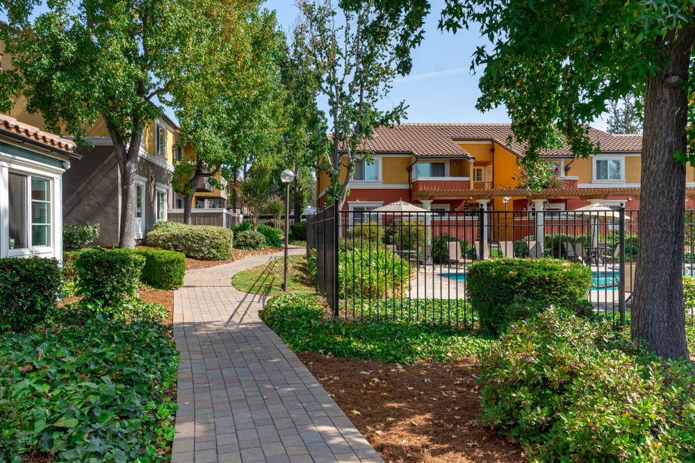 Exterior walking path to gated swimming pool