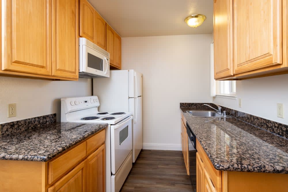 Kitchen with brown cabinets and white appliances