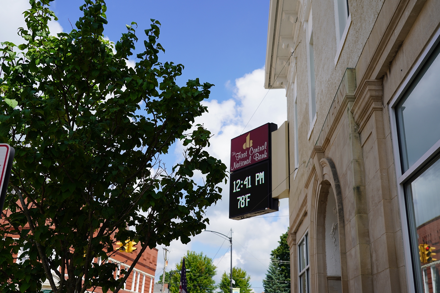 Sign for First Central National Bank showing time 12:41 PM and temperature 78°F on a sunny day.