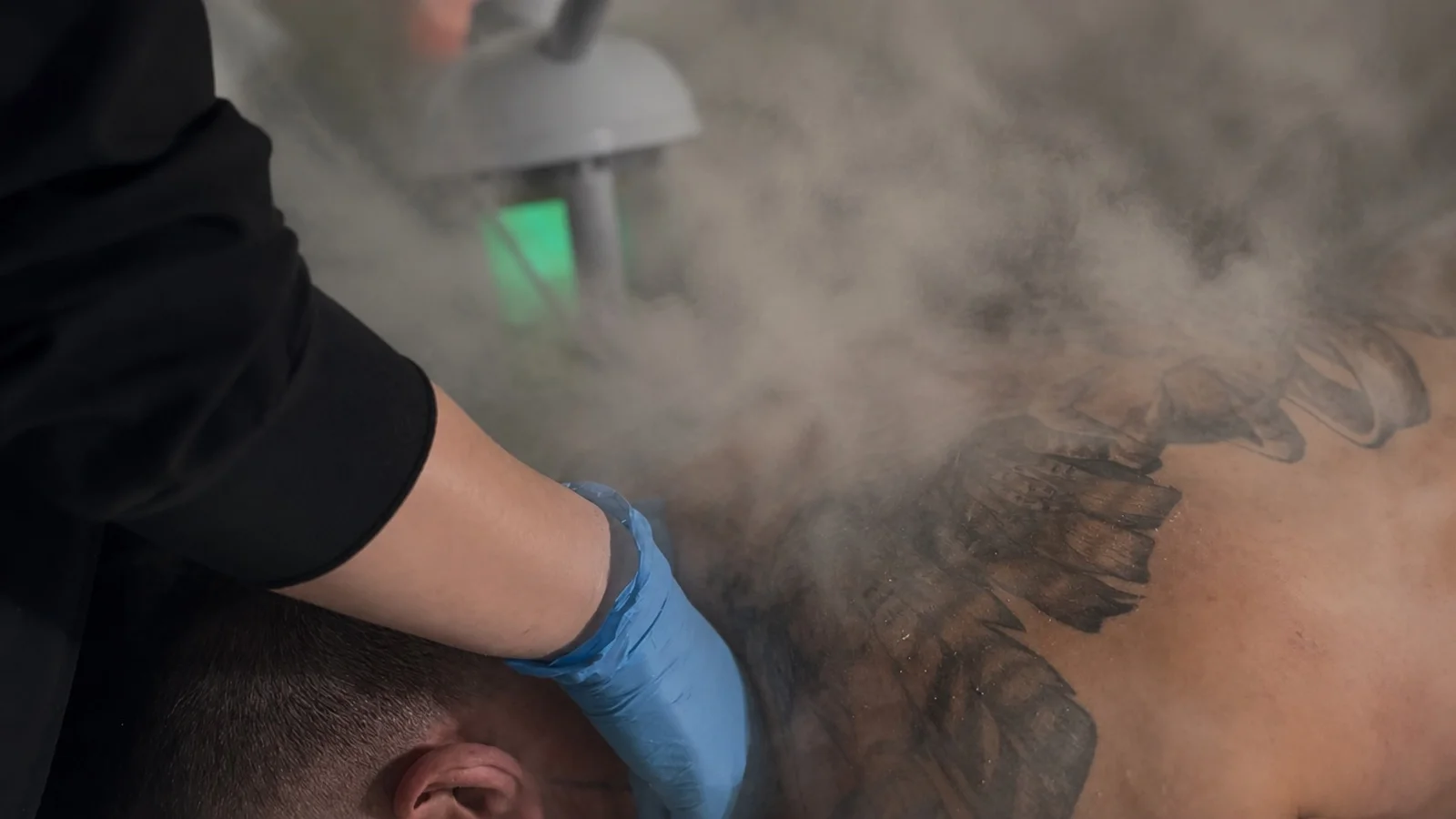 Esthetician steaming a client's back during a back facial session at our Montreal clinic