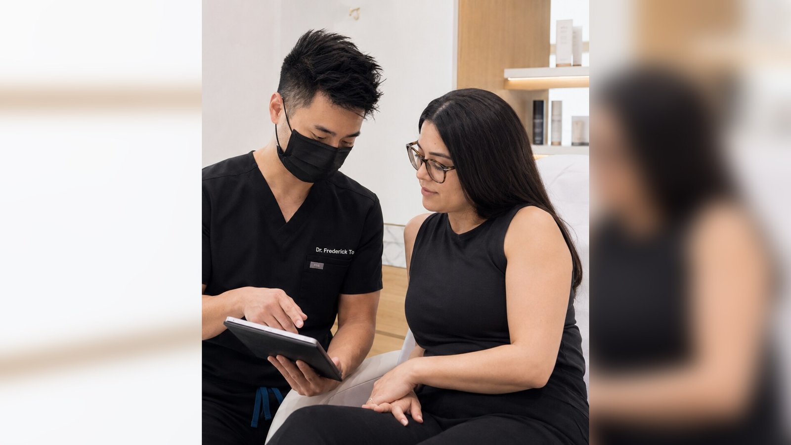 Physician reviewing a patient's file on a tablet during a hyperhidrosis treatment consultation