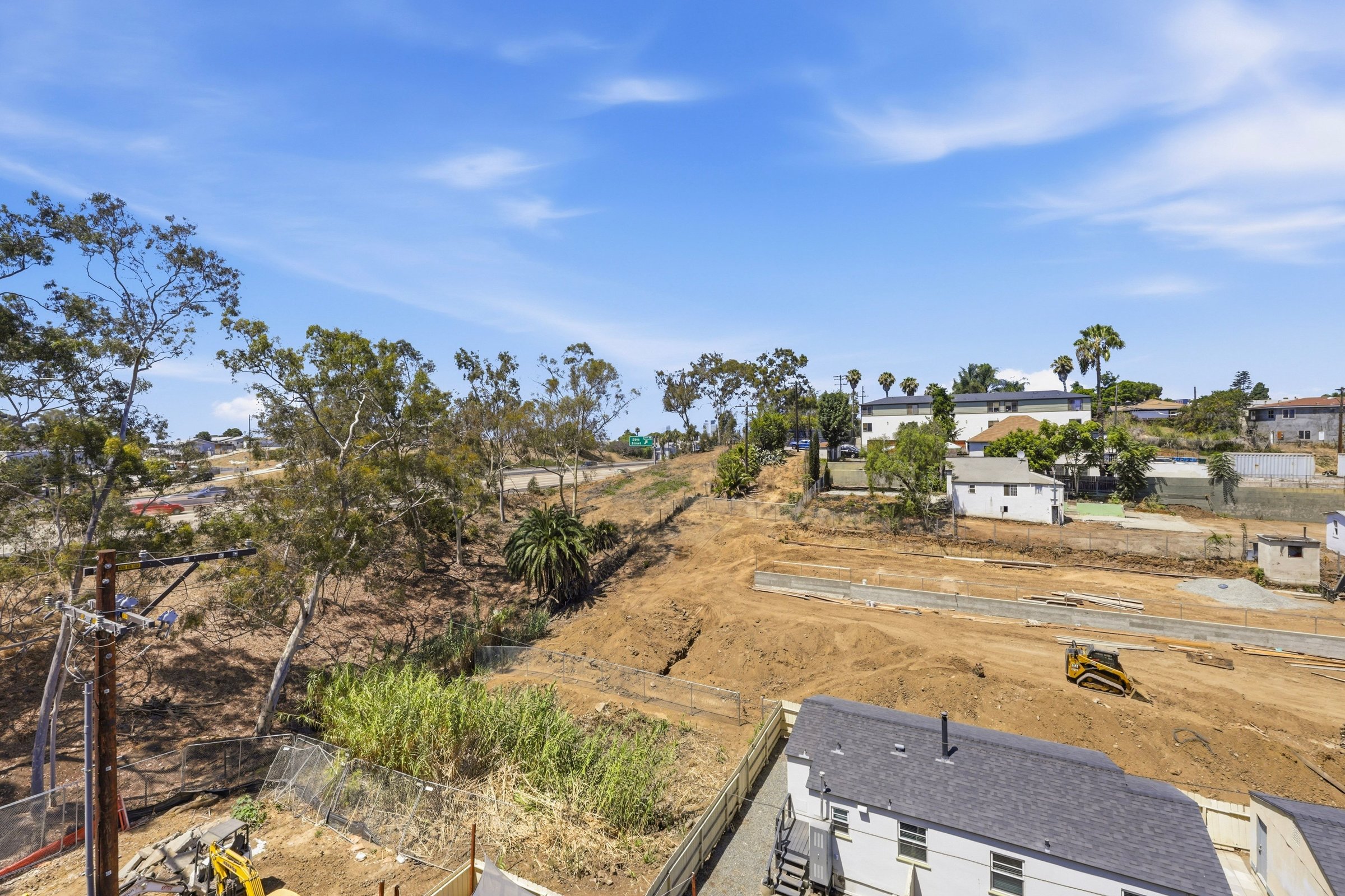 Neighborhood view from a Goldilocks apartment overlooking Golden Hill under a clear blue sky.