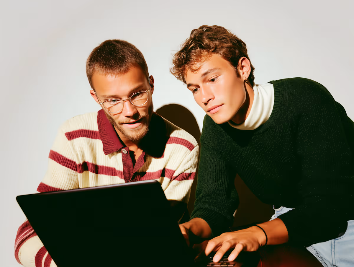 Two Men Using Laptop