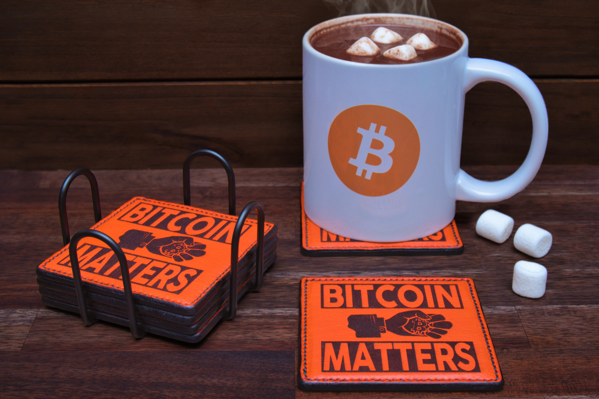 White mug with Bitcoin logo filled with hot chocolate and marshmallows on a Bitcoin Matters coaster.
