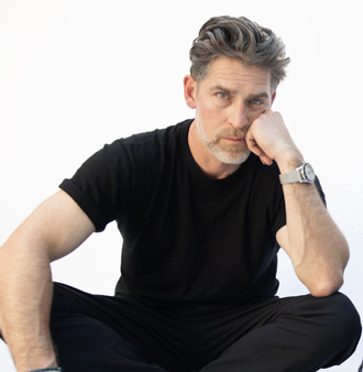 A portrait of Balls on the Table host Evan Hart