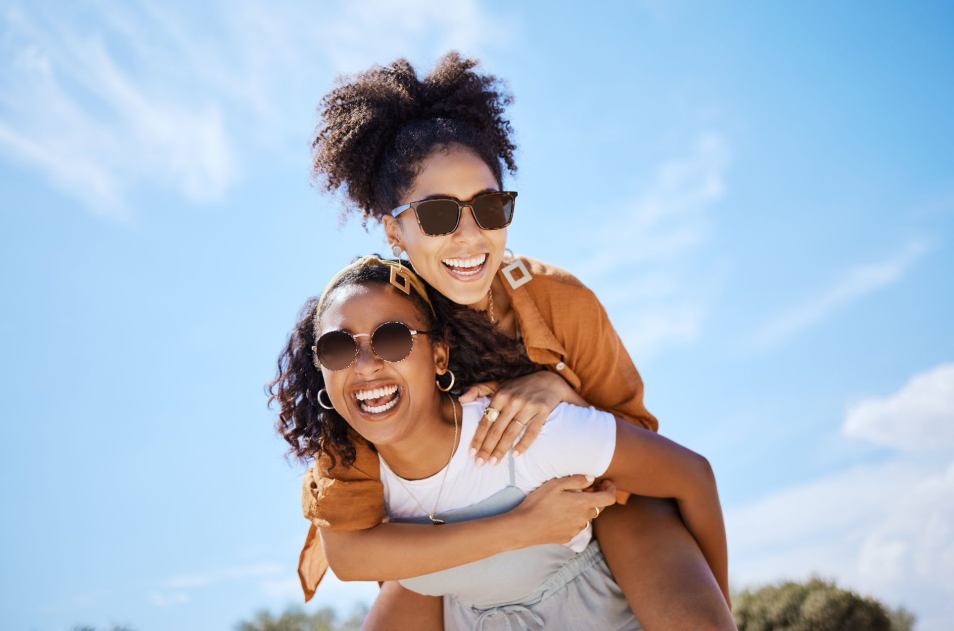 Woman holding up friend on her back while smiling stock image