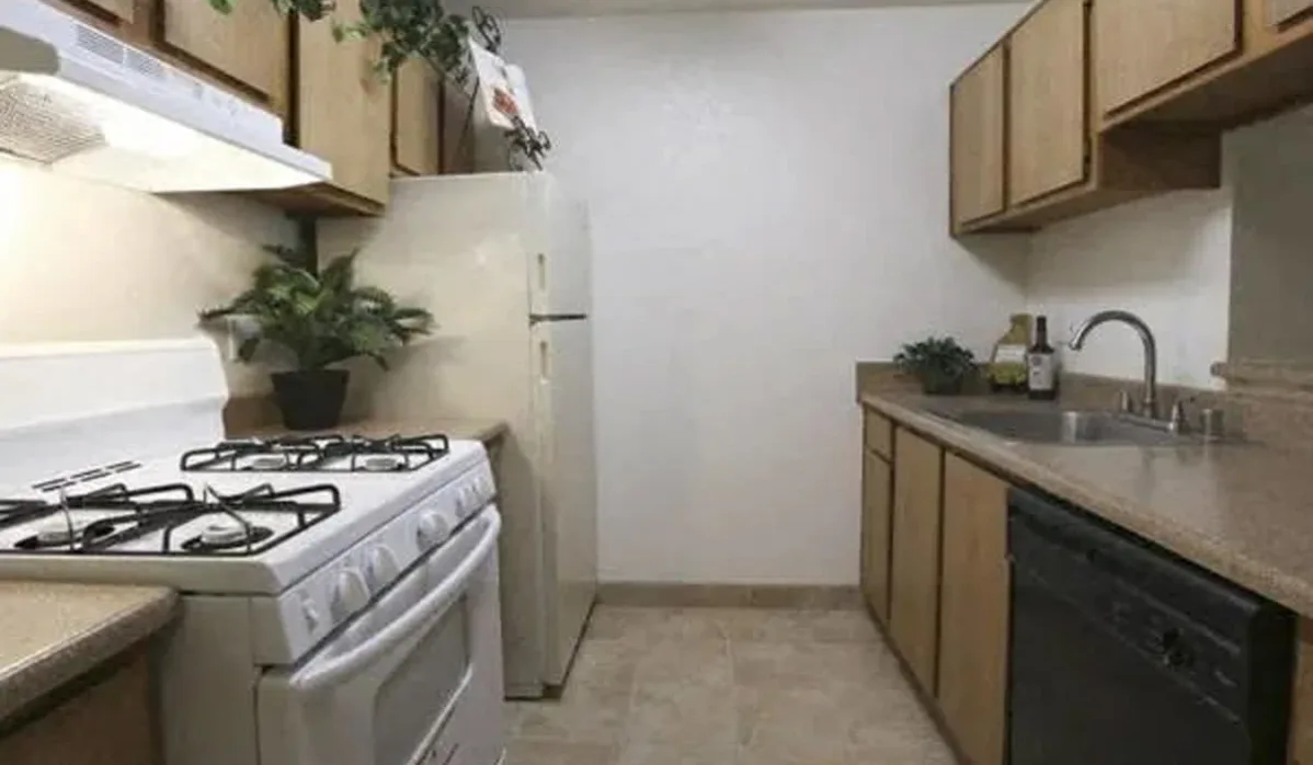 Kitchen with brown cabinets and white appliances
