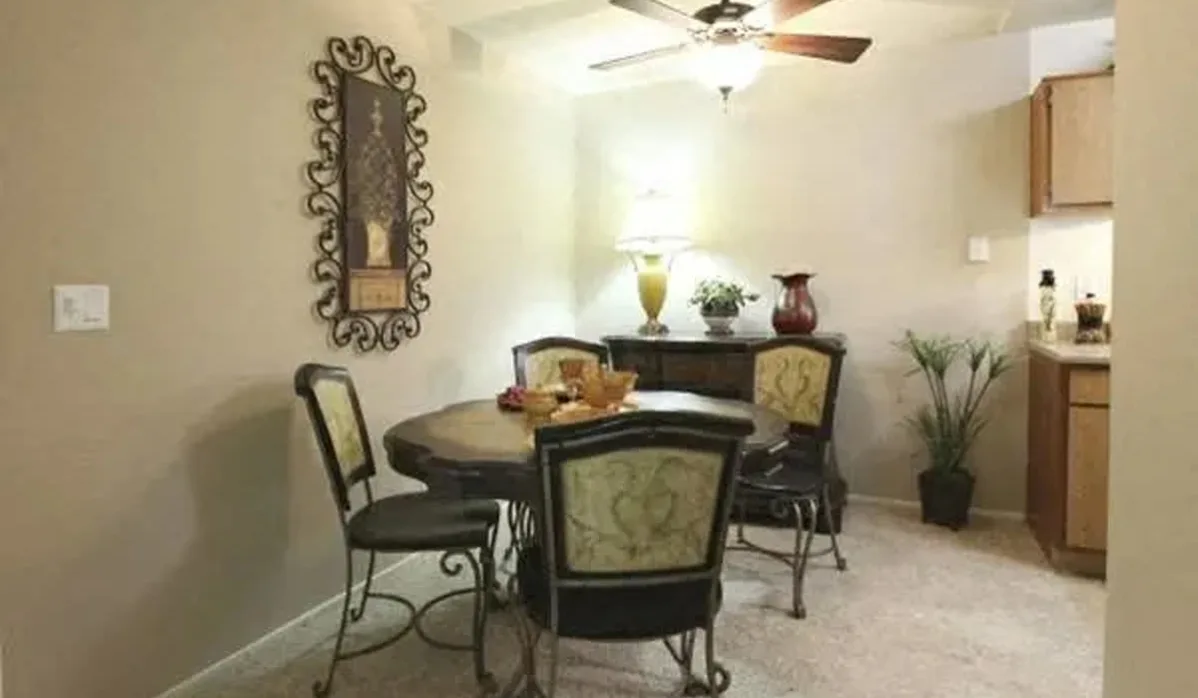 Dining area with chairs and table and view of kitchen