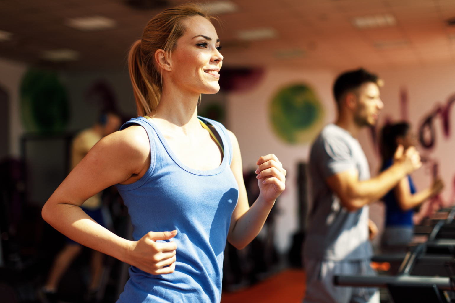 Woman running on treadmill stock image