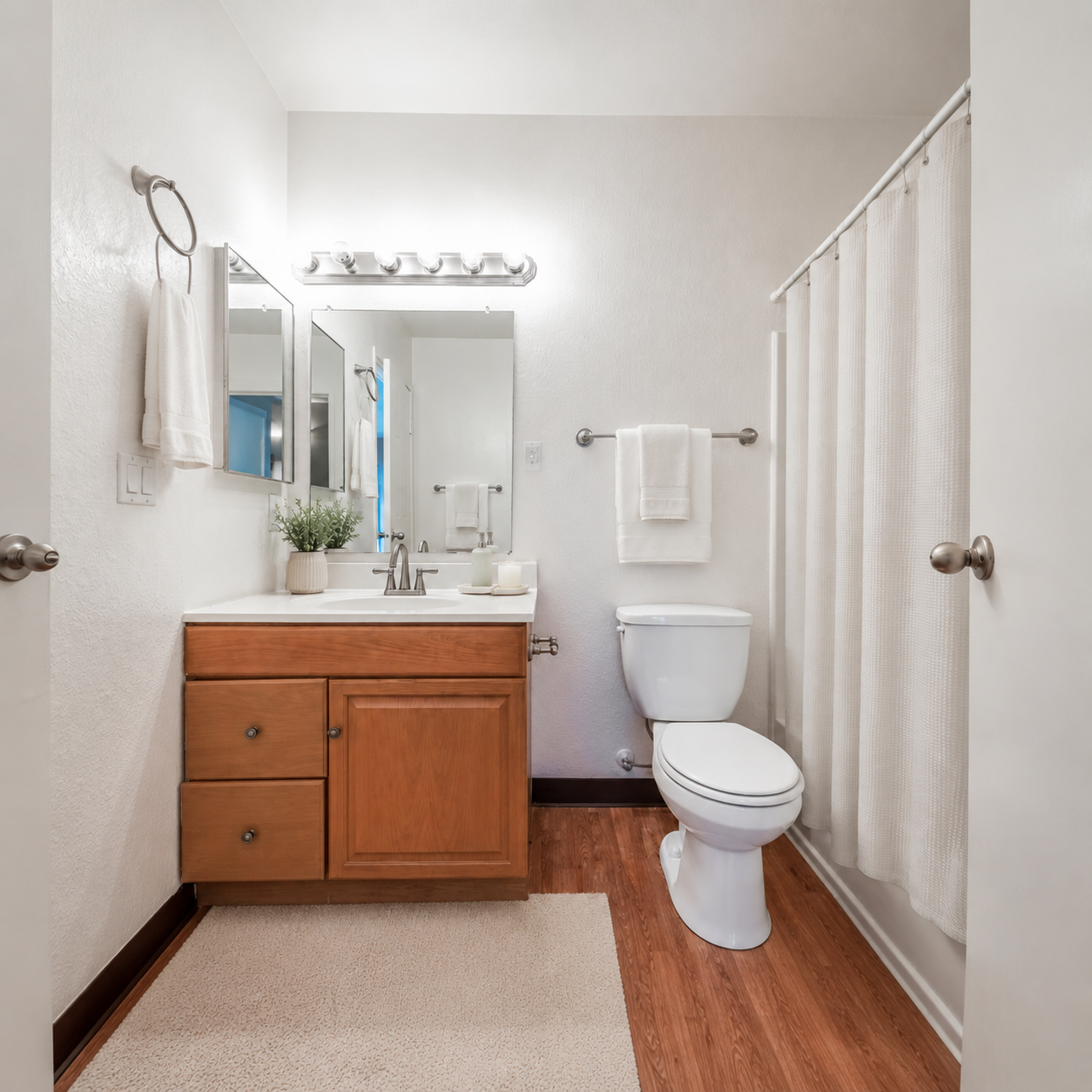 Bathroom with vanity with brown cabinets