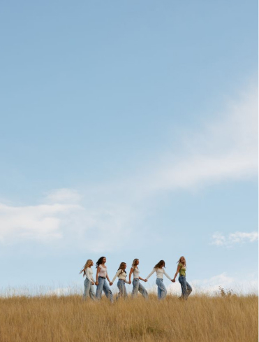 Group of friends sitting together and enjoying each other's company on an open field