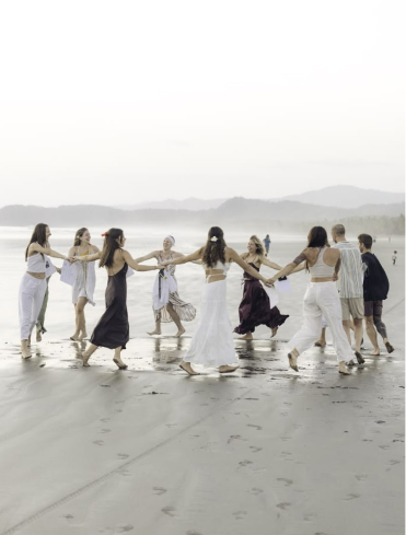 Group of friends smiling and socialising together on a beach