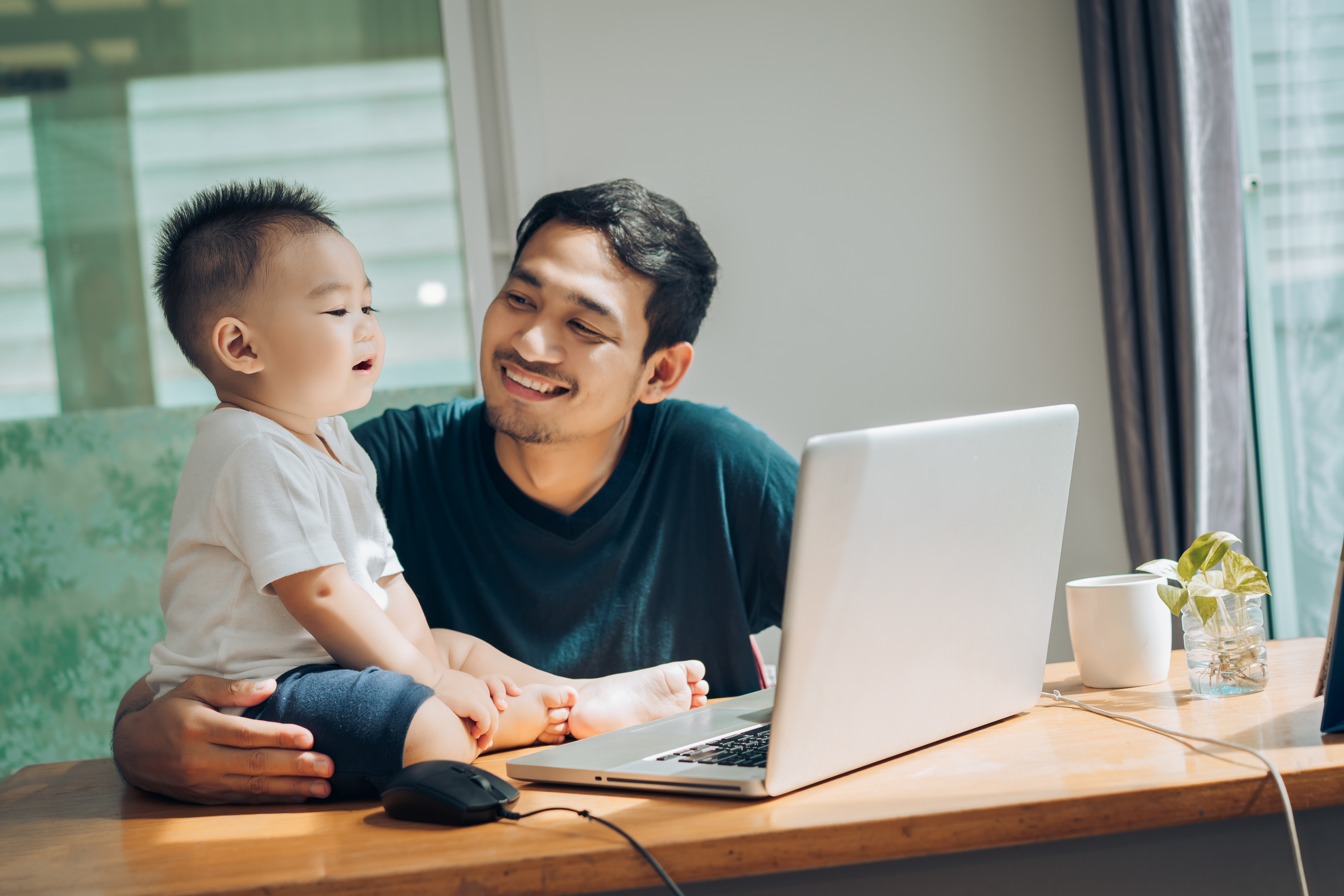 Man and son siting on the table stock image
