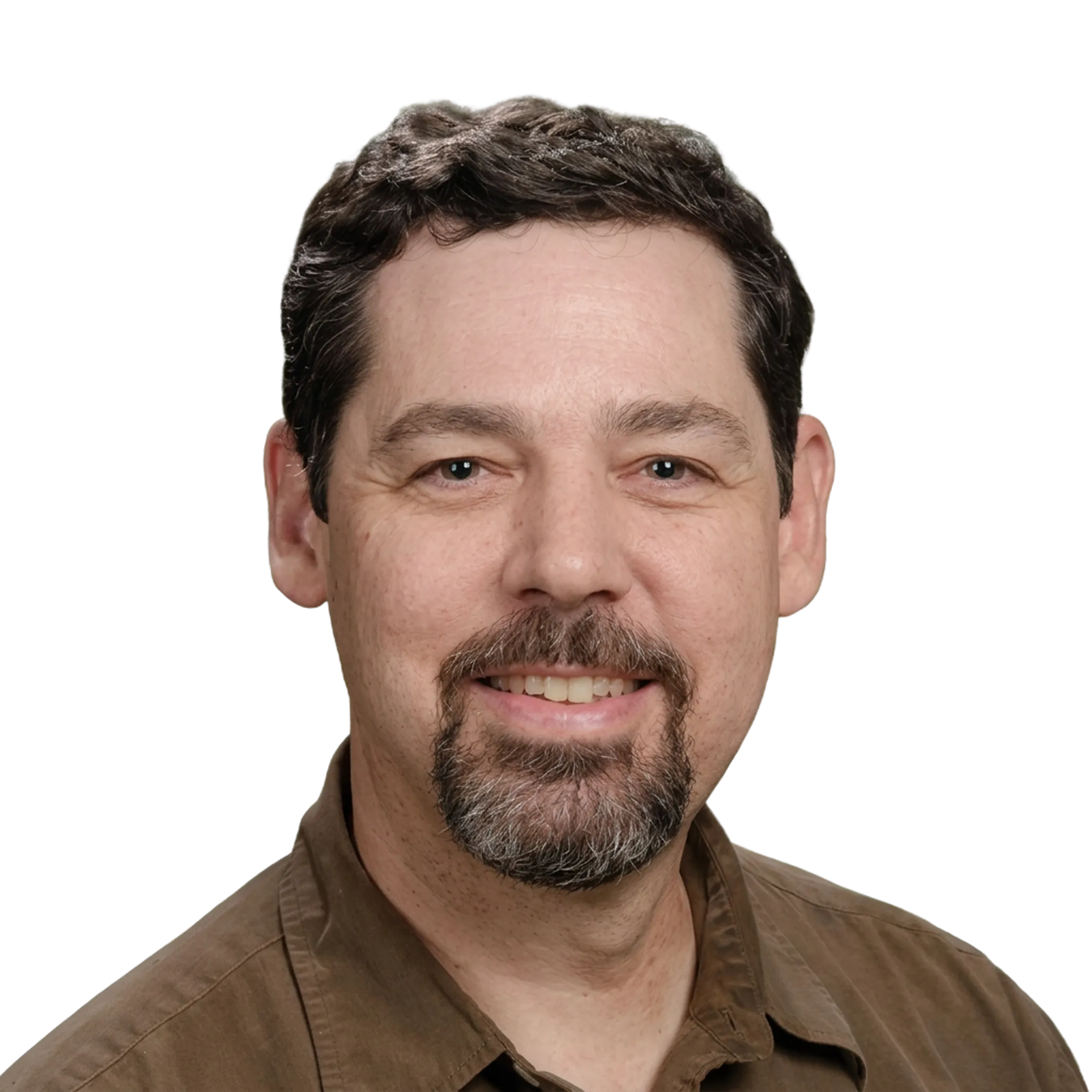 Smiling man with short dark hair, goatee, and brown shirt on black background.