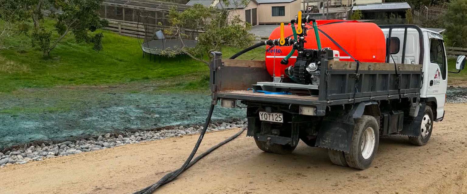 Boss Civil hydroseeding equipment spraying grass seed slurry across a prepared subdivision site in Whanganui