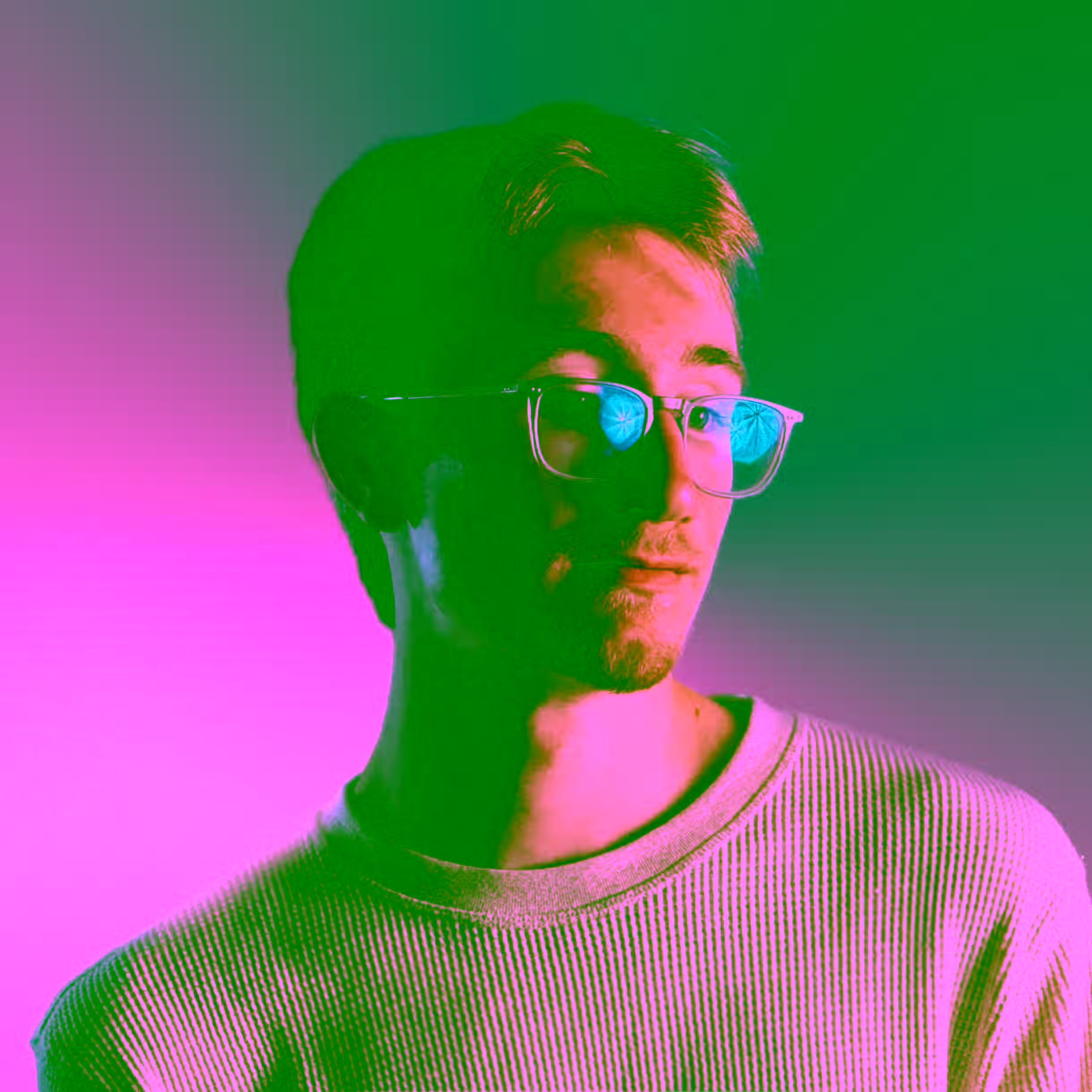 Chris Tobey in front of a colorful background.