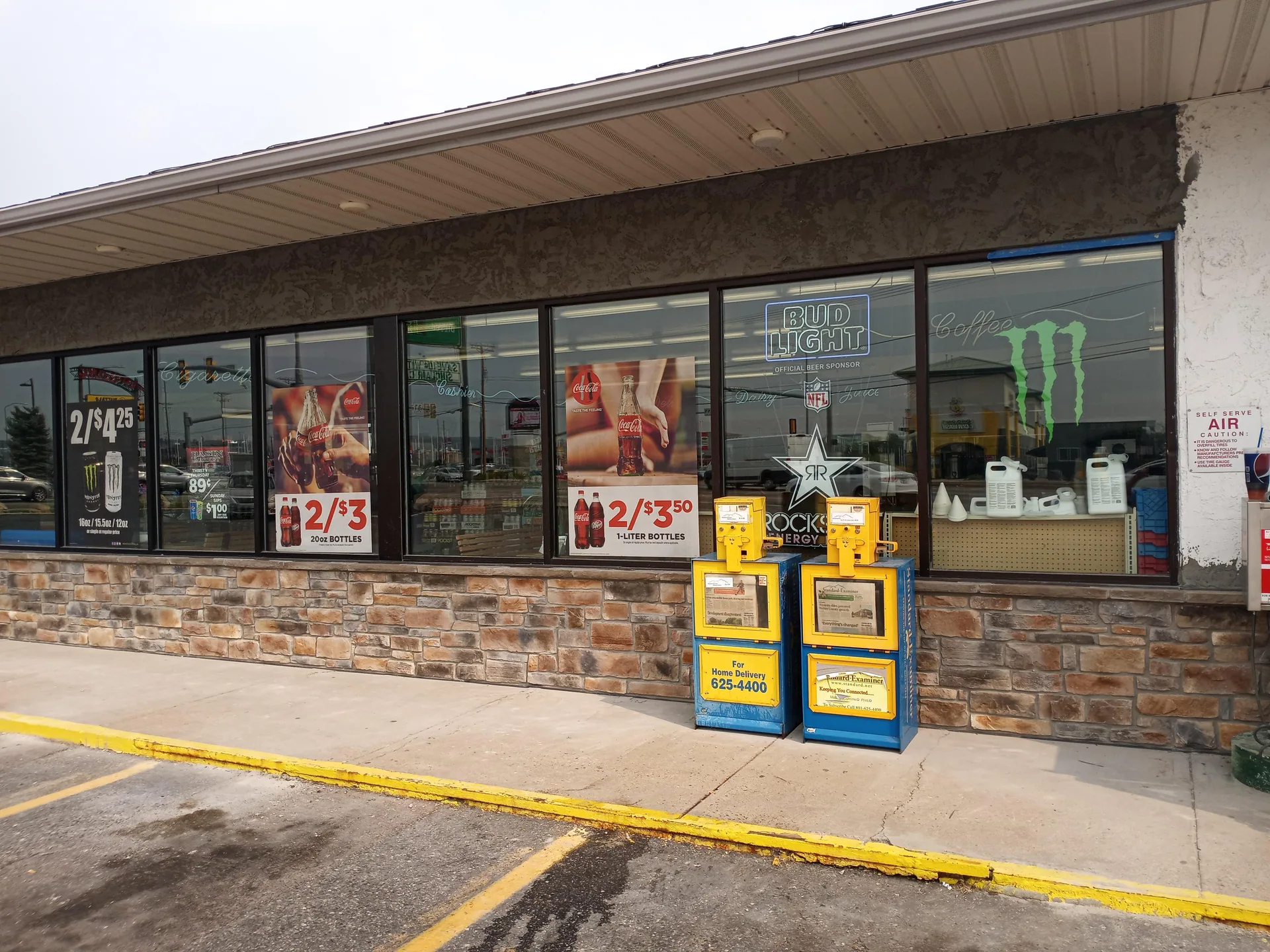 Storefront with stone base and repaired trim below windows.