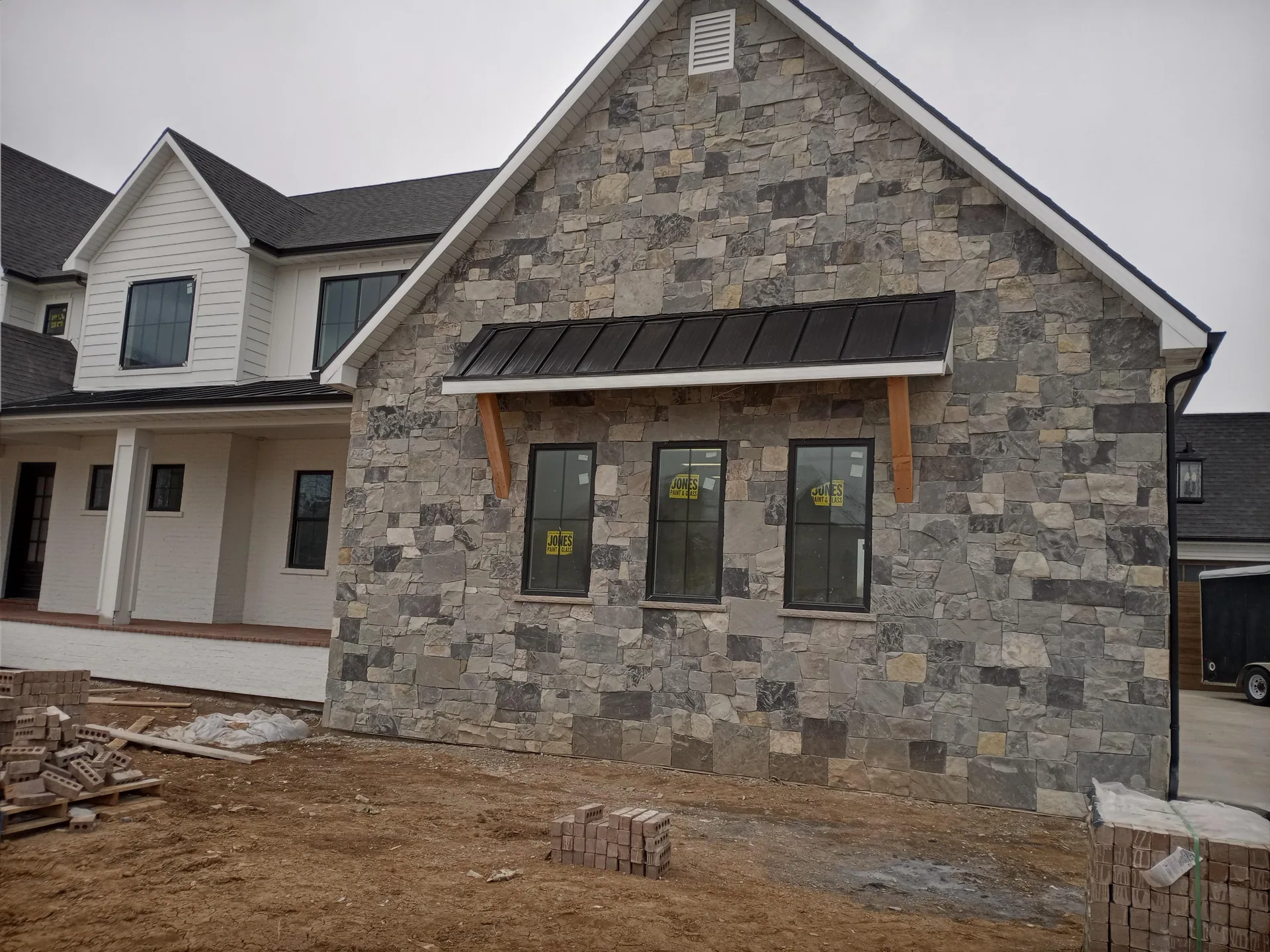 House under construction with stone exterior wall.