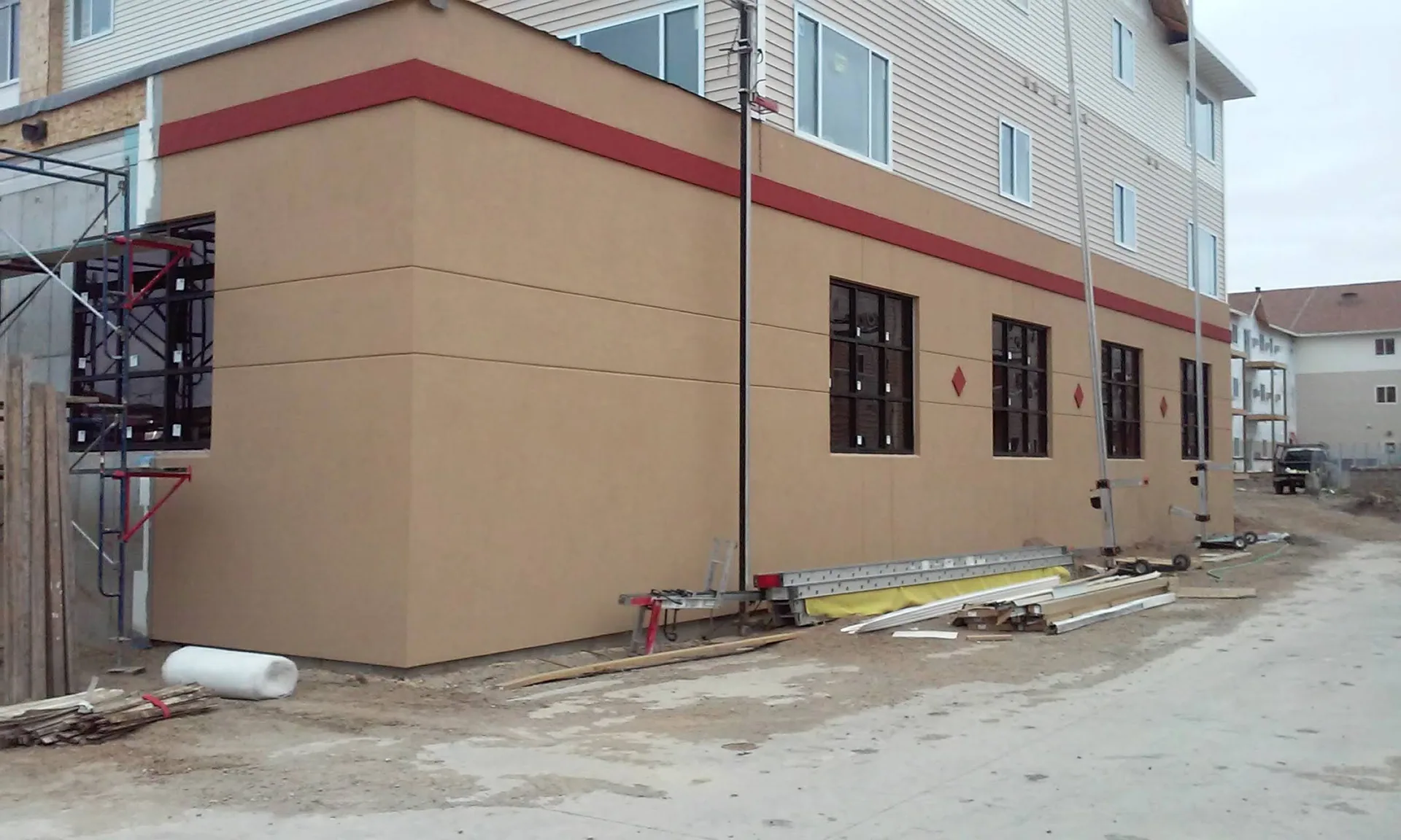 Complex showing new stucco installation process.