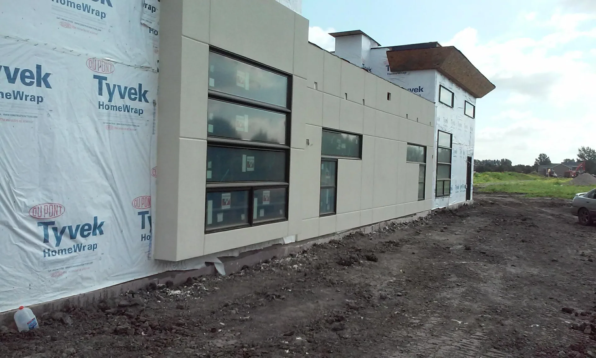Building under construction with Tyvek HomeWrap and new windows.