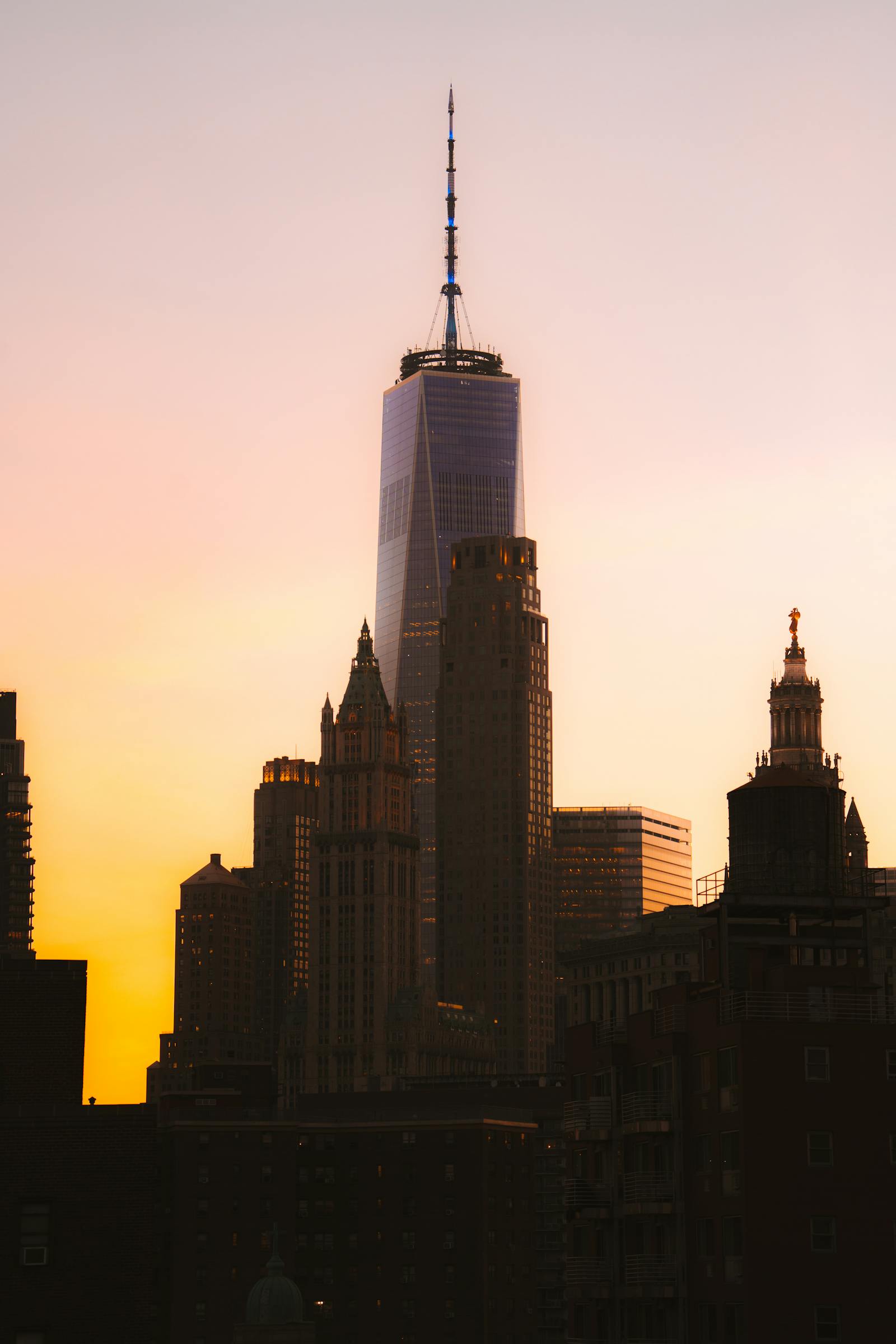 Breathtaking view of NYC skyline featuring One World Trade Center at sunset, showcasing urban architecture. Photo by Luke Miller on Pexels.