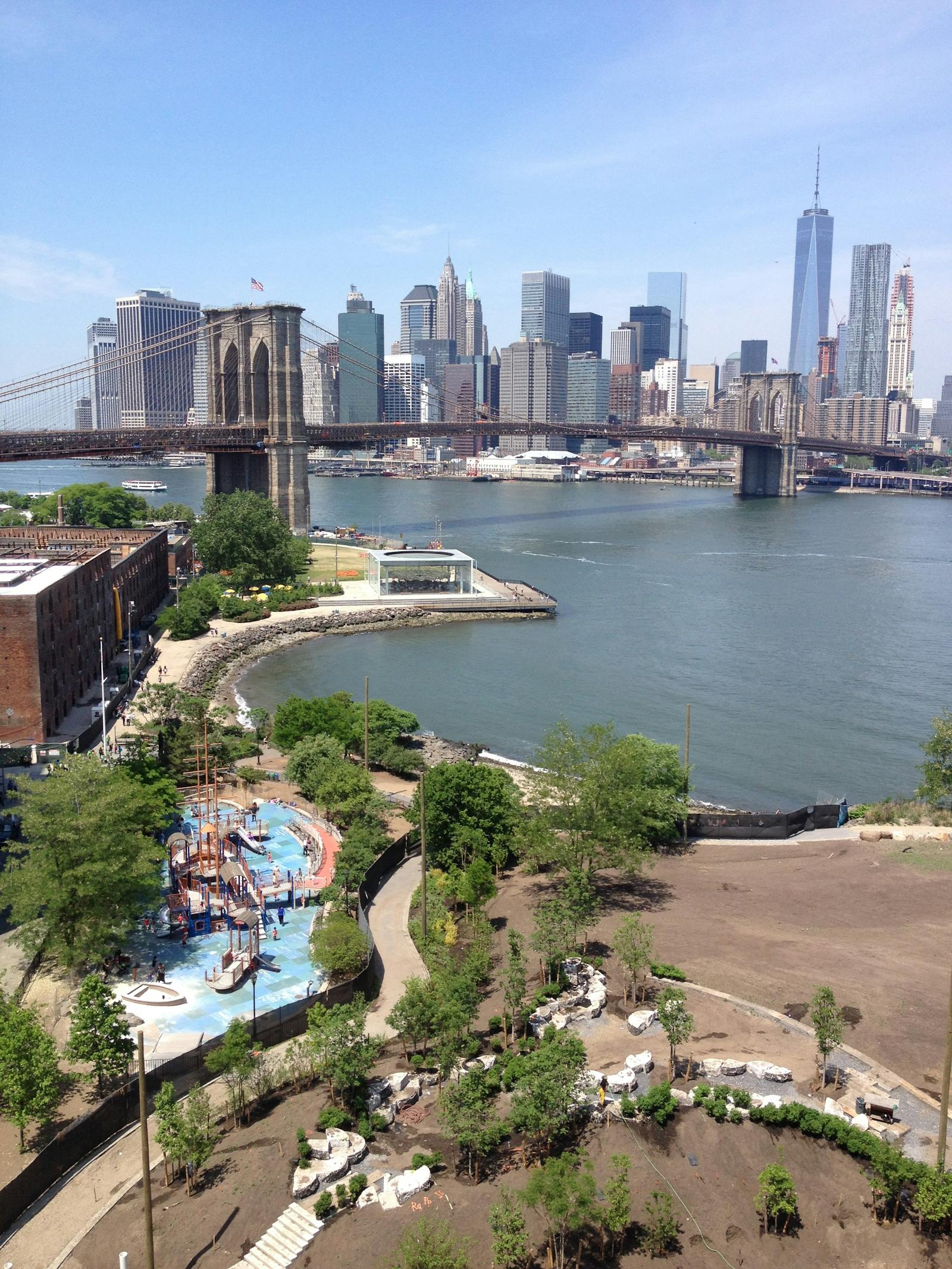 A clear view of the Brooklyn Bridge and New York City skyline under a bright sky. Photo by William Wade on Pexels.