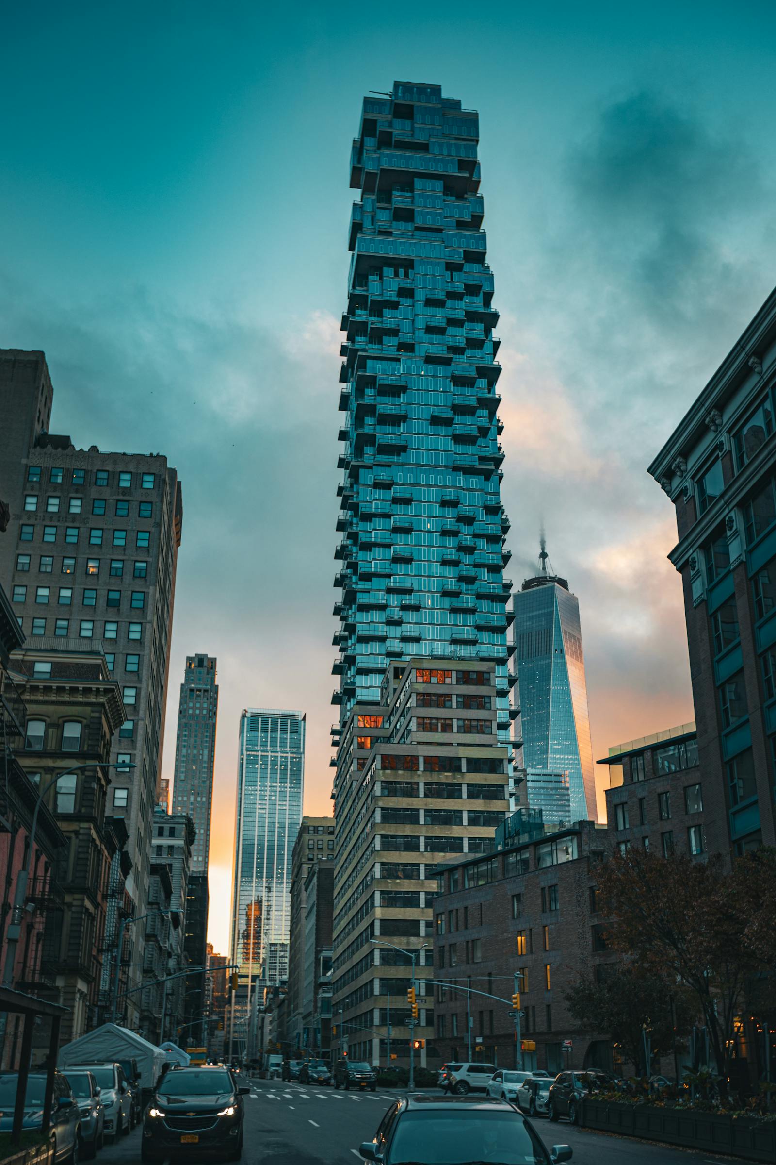The 56 Leonard Street Jenga tower in Tribeca with One World Trade Center in the distance at dusk. Photo by Brent Singleton on Pexels.