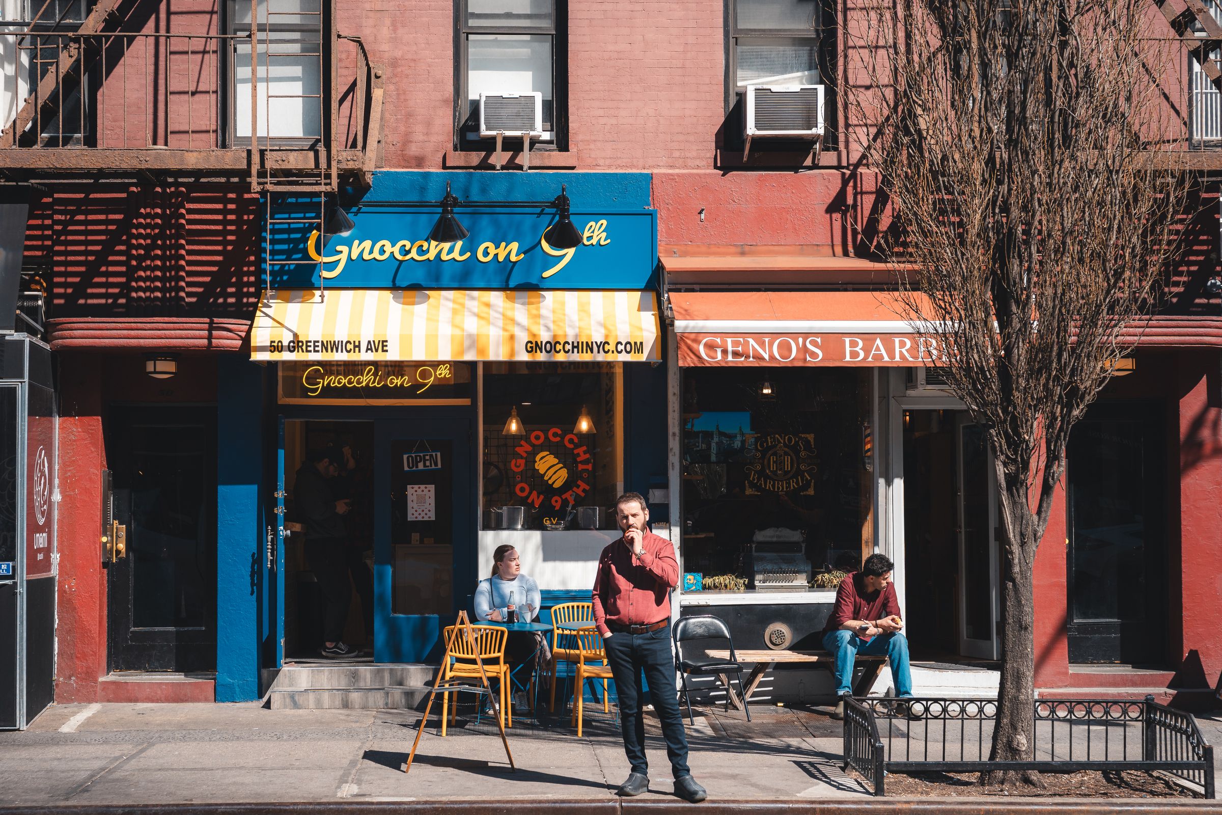 Sunlit storefront of an Italian restaurant with sidewalk tables on a Greenwich Village block in New York. Photo by Willian Justen de Vasconcellos on Pexels.