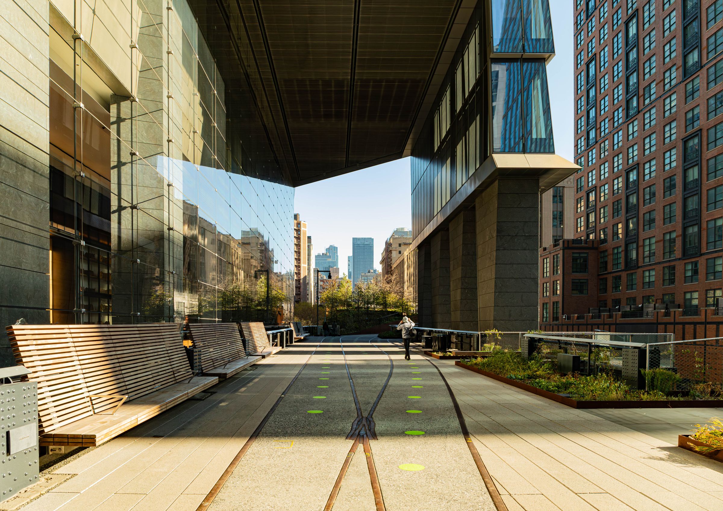 The High Line walkway threading between modern glass towers and brick facades near Hudson Yards. Photo by Richard Harris on Pexels.