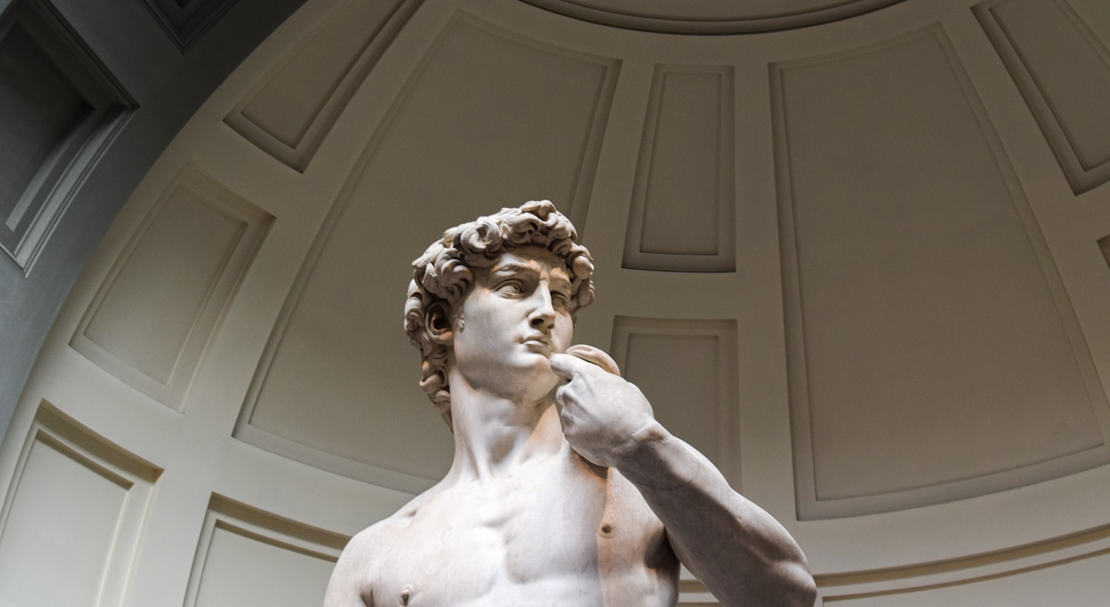 Michelangelo's David under the dome built for him at the Galleria dell'Accademia. Photo by Mateus Campos Felipe on Unsplash.