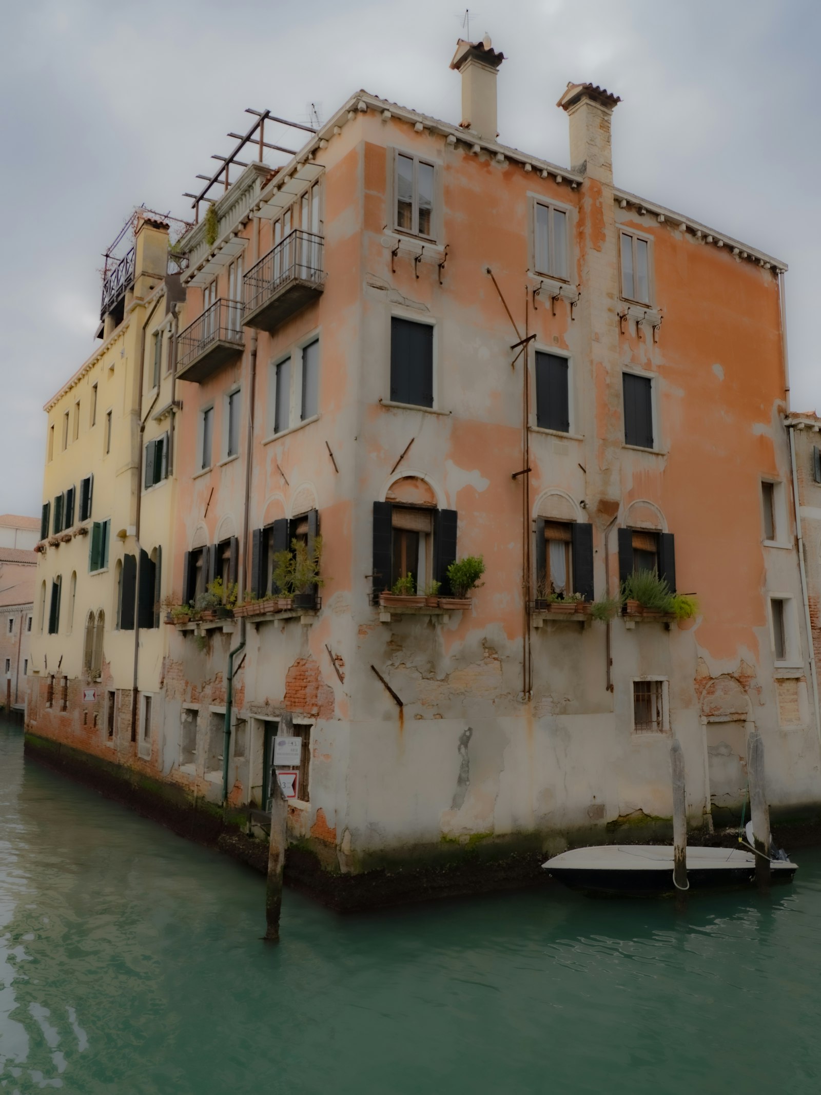 Weathered Venetian facades stacked along a quiet canal. Photo by Diego Romeo on Unsplash.