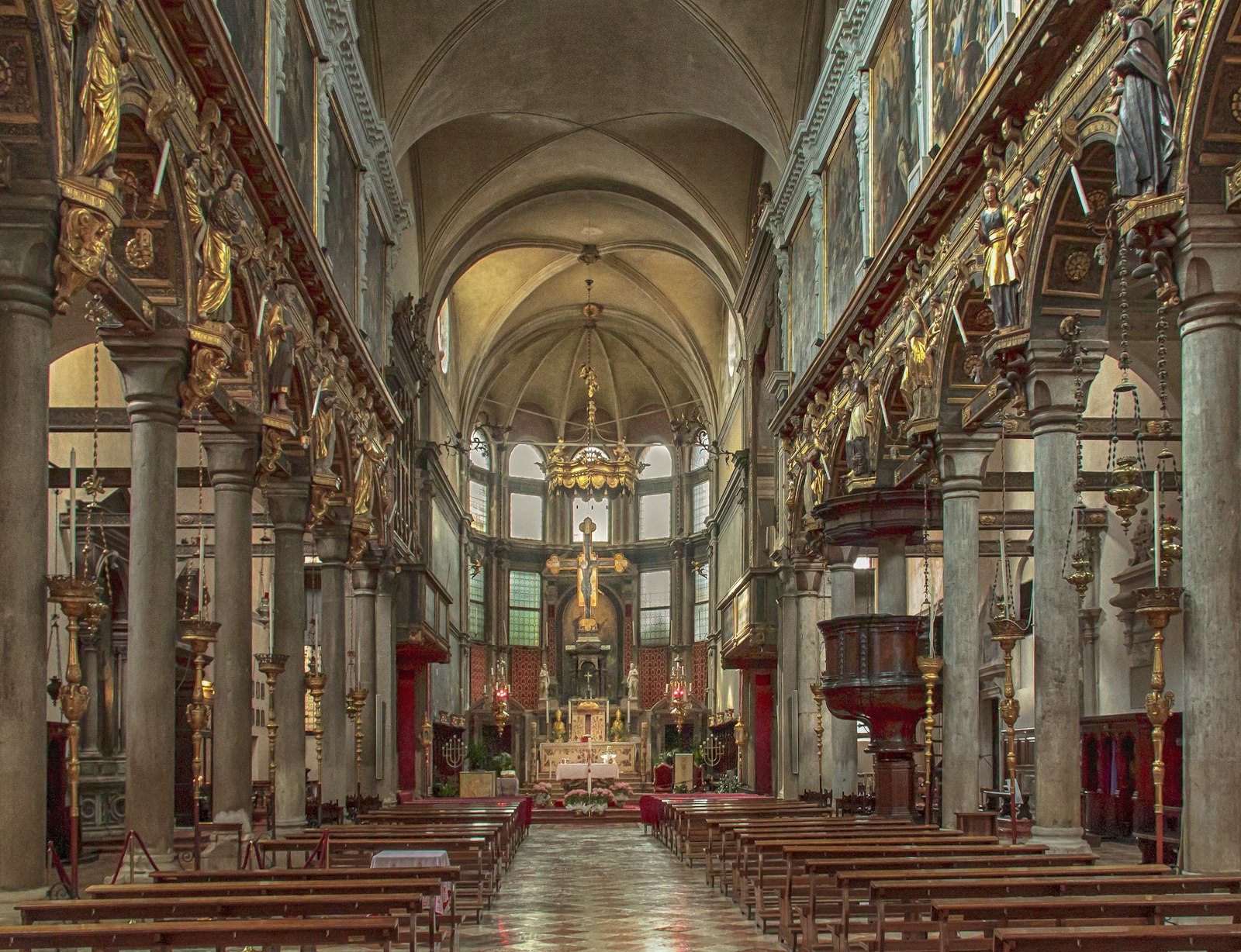 Golden light down the nave of a Venetian church. Photo by Sterling Lanier on Unsplash.