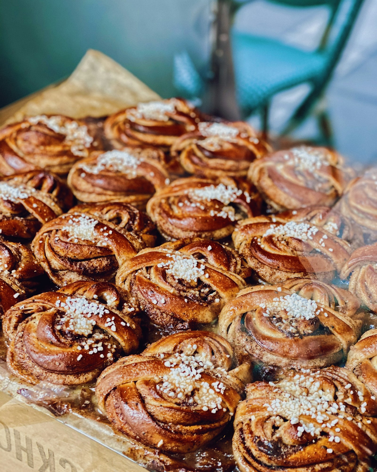 Trays of kanelsnegle behind a bakery window. Photo by Oscar Nord on Unsplash.