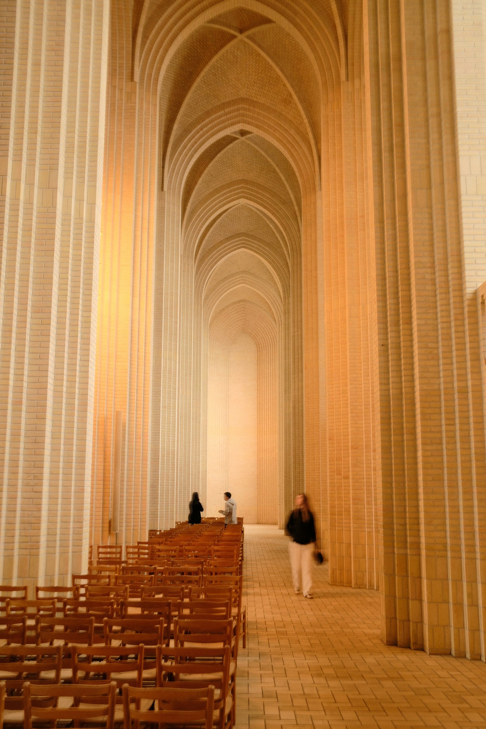 The pale brick nave of Grundtvig's Church. Photo by Daniel Koponyas on Unsplash.