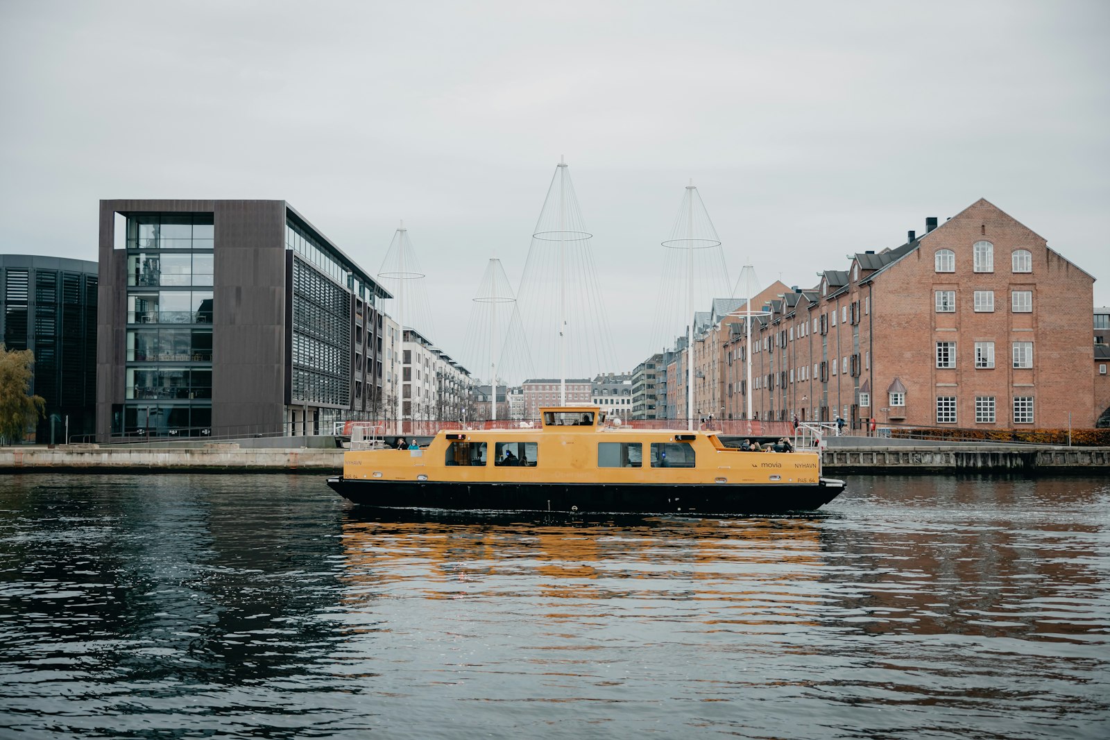 A yellow harbor bus ferry crossing the main channel. Photo by Febiyan on Unsplash.