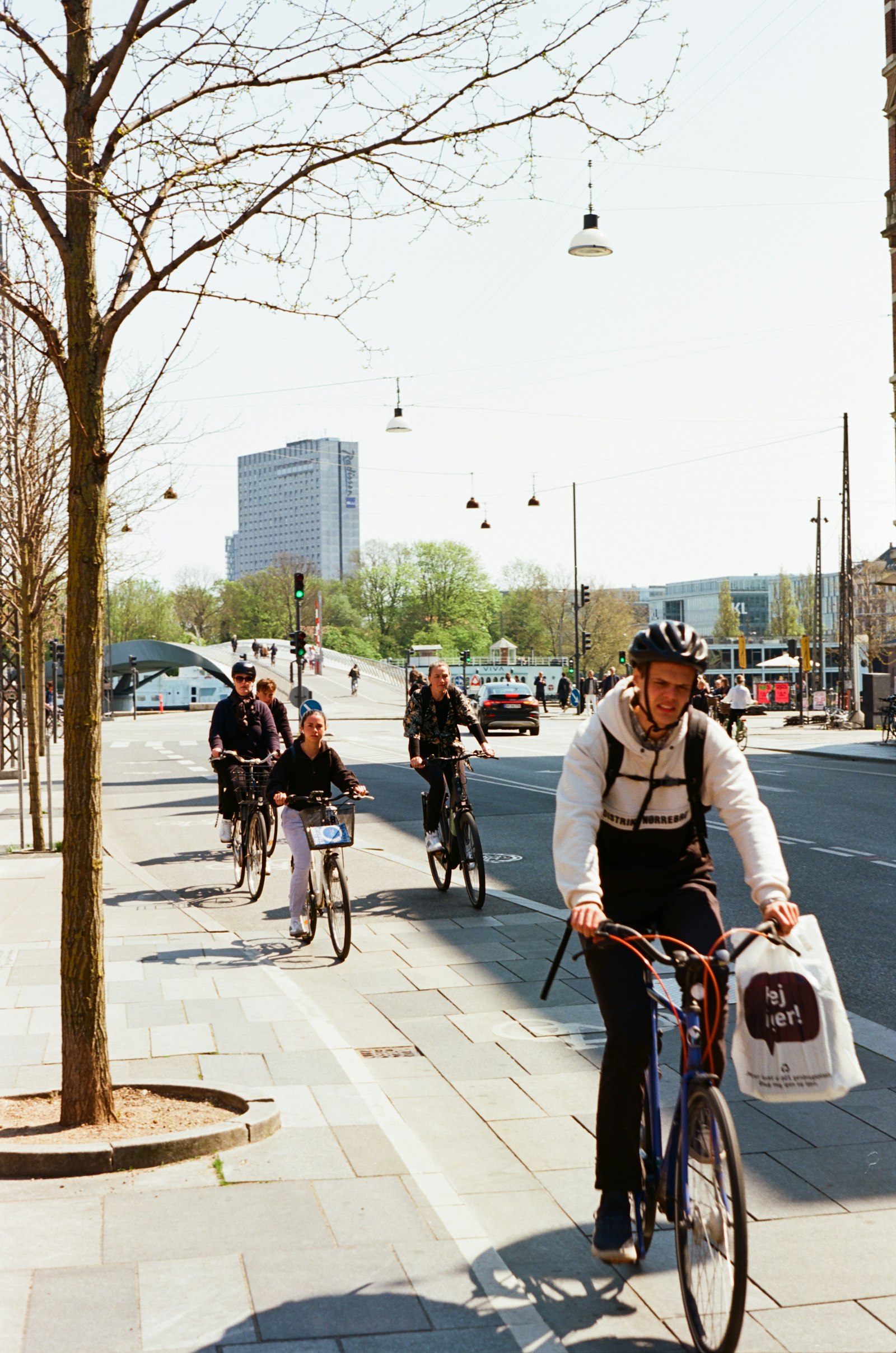 Commuters on a Copenhagen bike lane in spring. Photo by Nate Holland on Unsplash.
