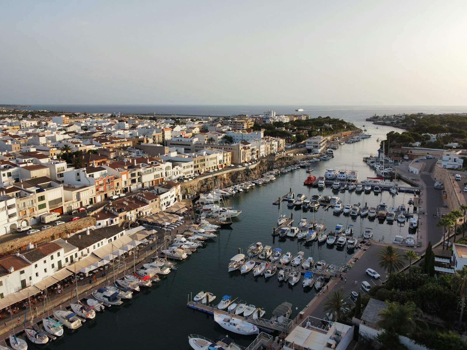 Boats moored in Ciutadella's old harbour. Photo by Alberto Almajano on Unsplash.