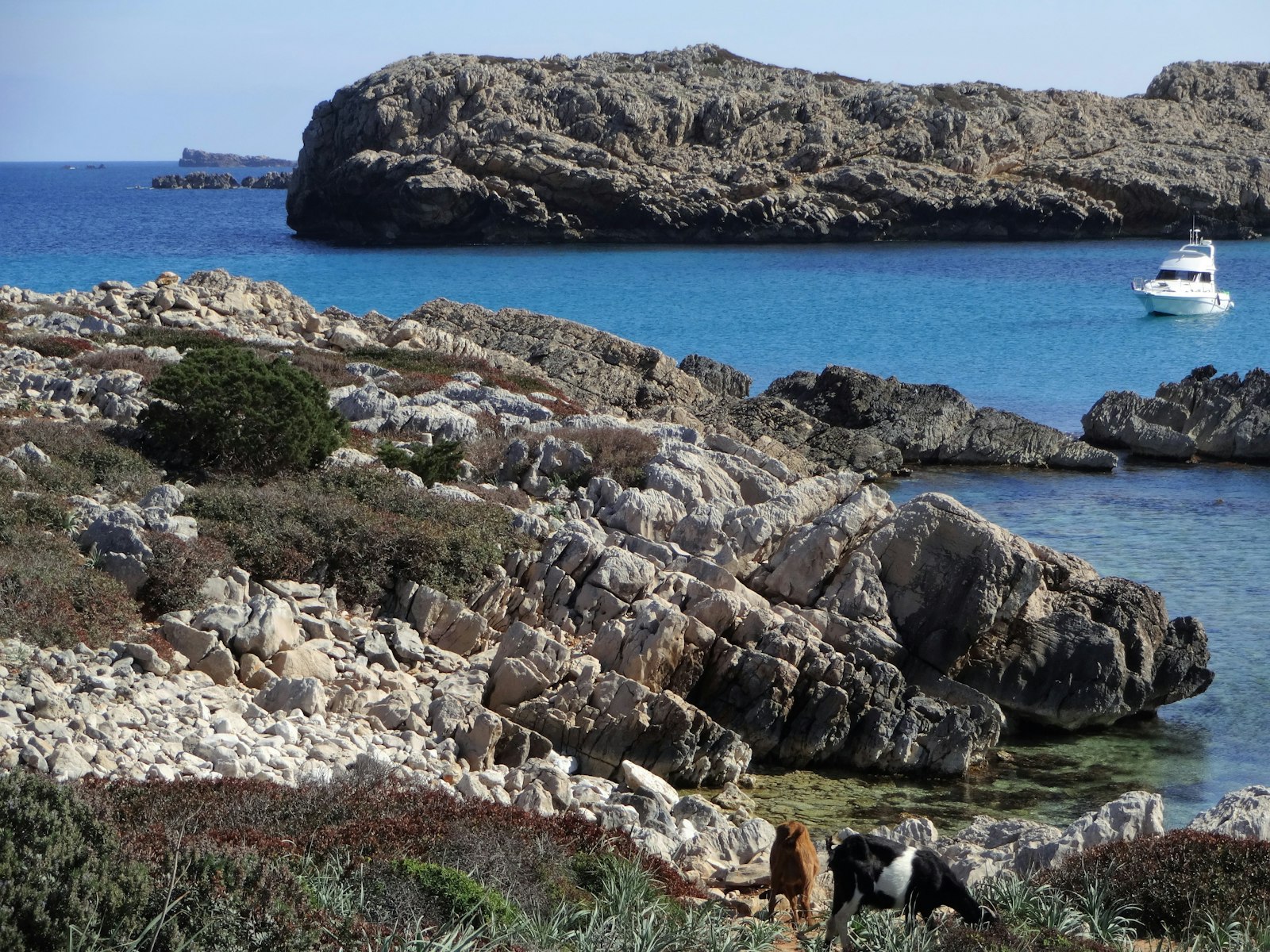 A rocky natural arch on Menorca's wild coast. Photo by Roving Wanders on Unsplash.