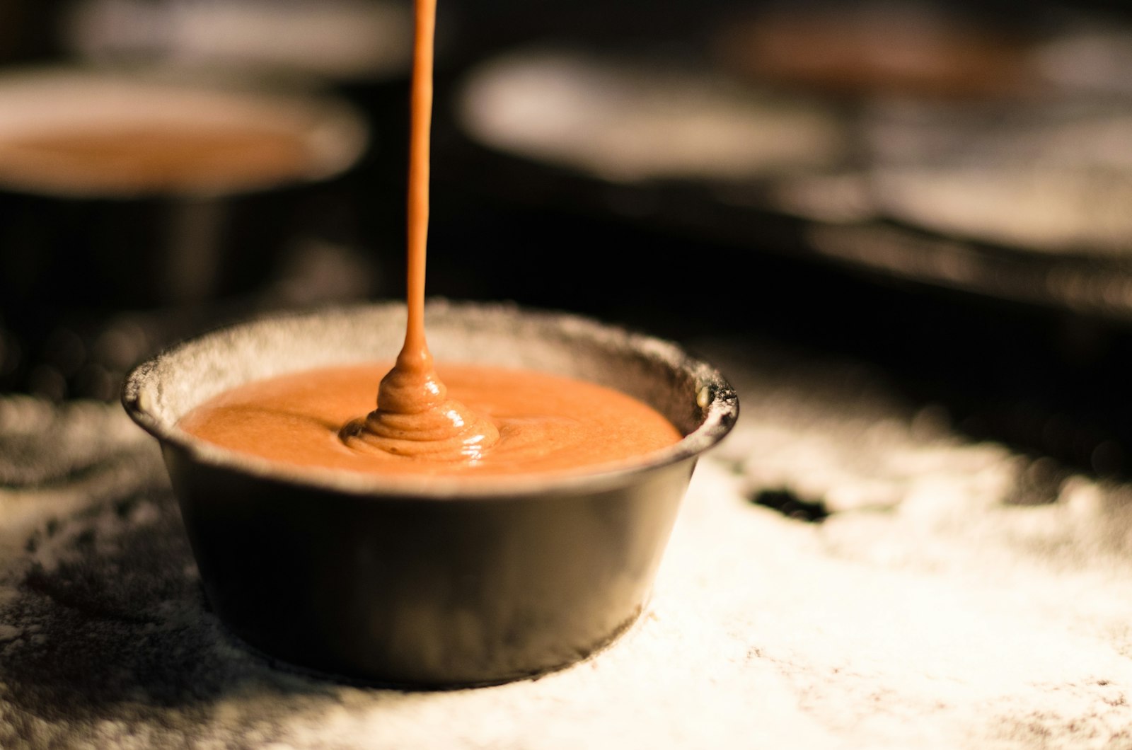 Dulce de leche being poured, the national sweet of Argentina. Photo by Theo Crazzolara on Unsplash.