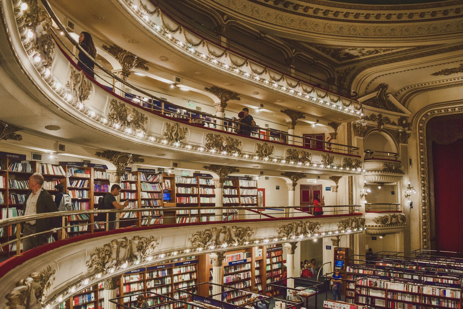 Tiered balconies of books inside El Ateneo Grand Splendid. Photo by Noralí Nayla on Unsplash.