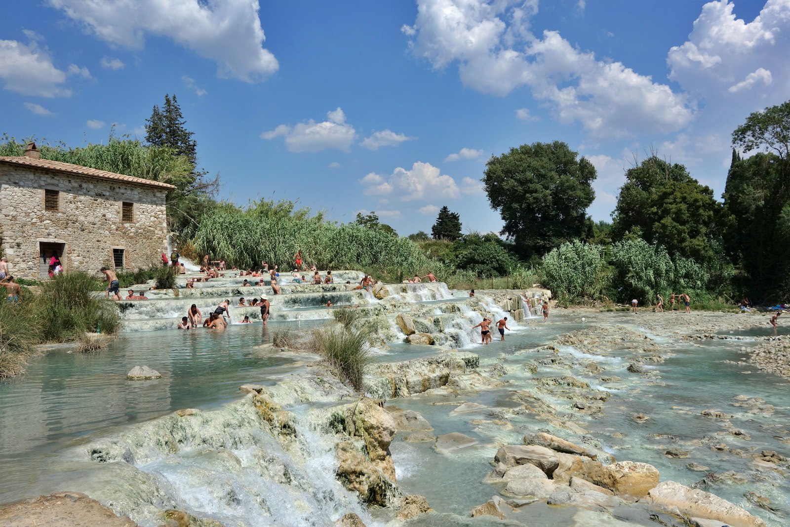 The white travertine terraced pools of the Saturnia hot springs. Photo by Ulf Meyer on Unsplash.