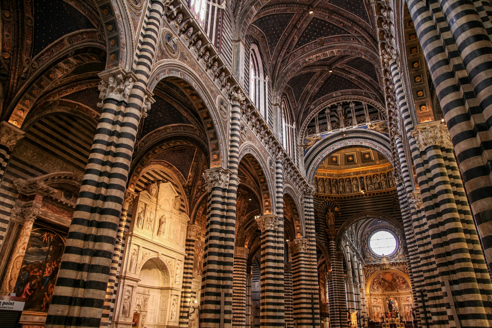 The black-and-white striped marble columns inside Siena's Duomo. Photo by Mario La Pergola on Unsplash.